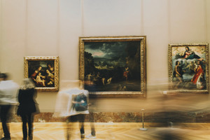 at an art museum, secretly planning a heist cover